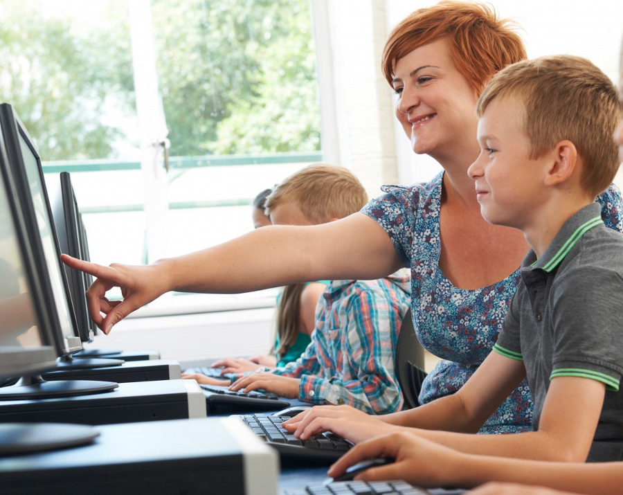Teacher with students on computers